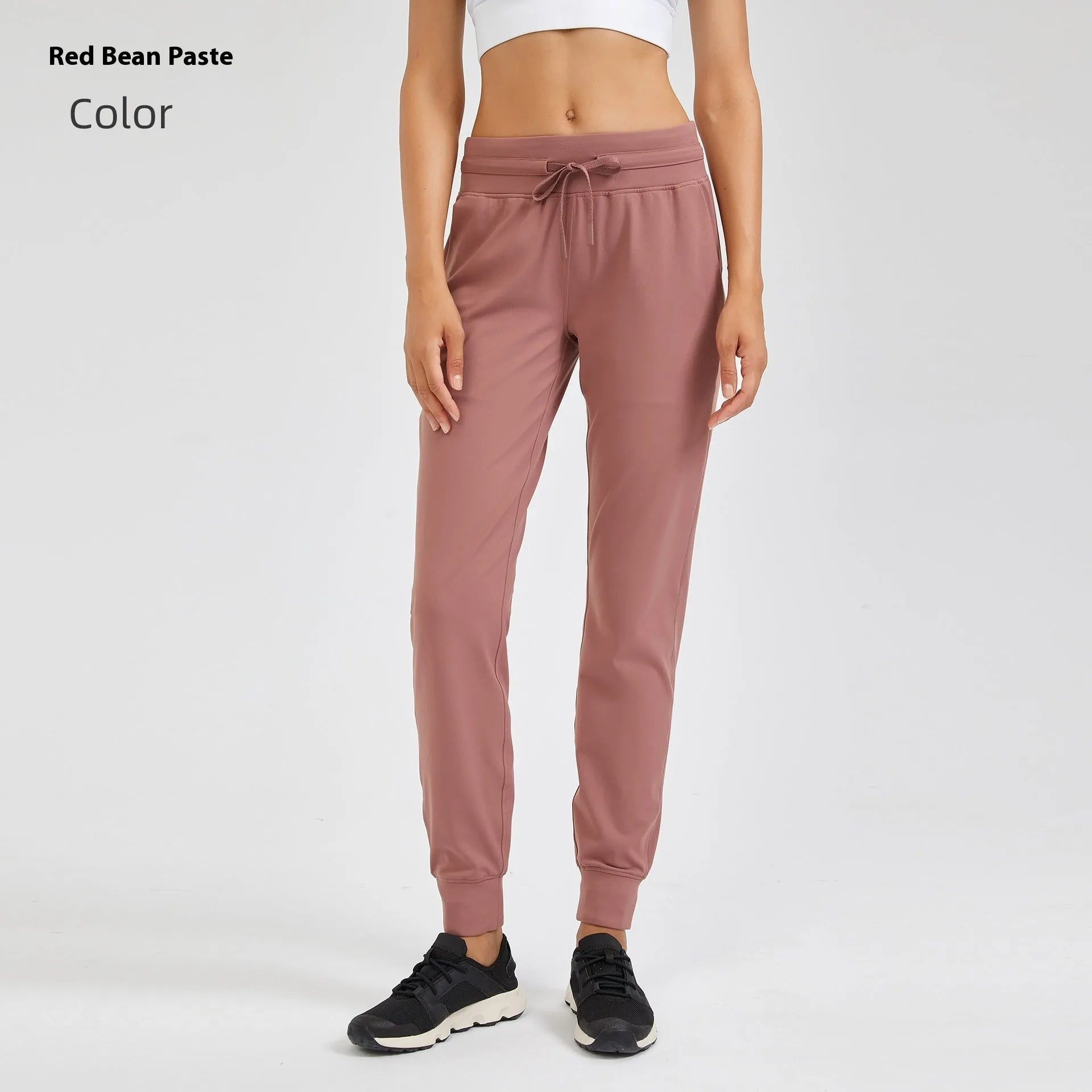 Women's high-waist yoga pants with drawstring waistband in a cotton blend fabric.