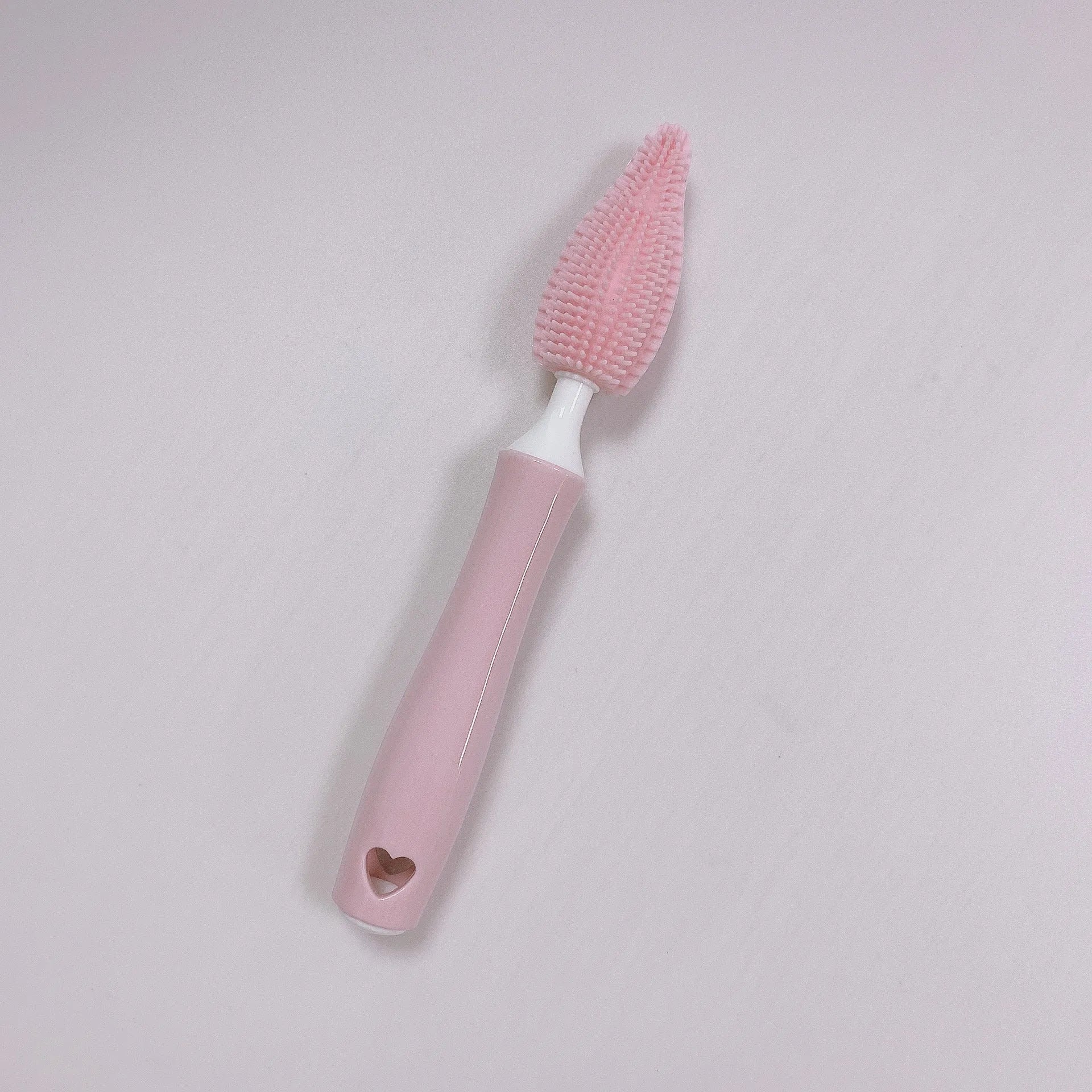 Three-piece baby bottle cleaning brush set with silicone bristles and a straw cleaner in assorted colours.