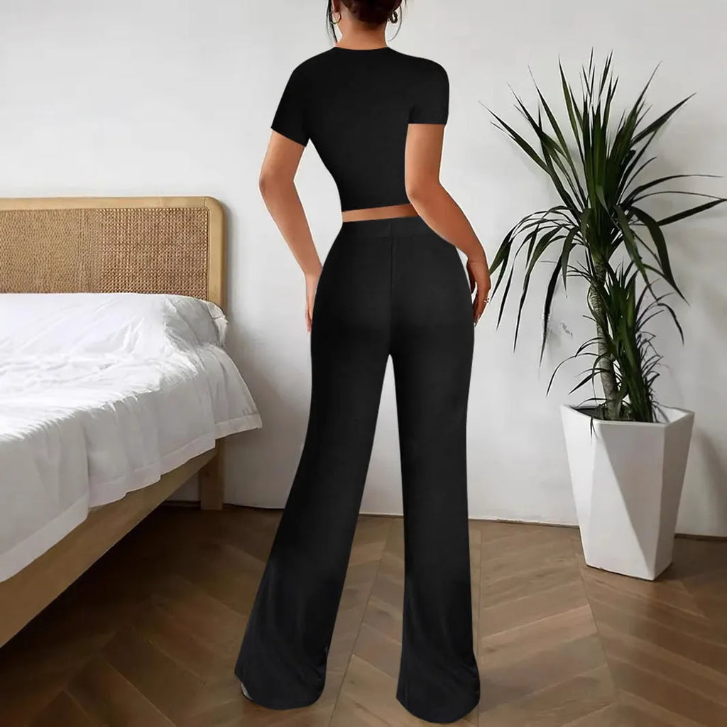 Black high-waist trousers and short sleeve t-shirt co-ord set for women.