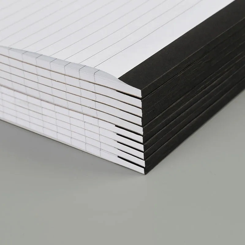 A4 tearable grid notebook with ivory white pages and adhesive binding, shown in open position