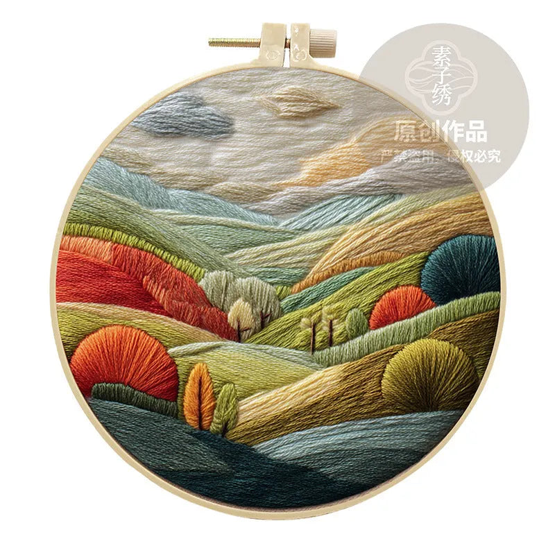 Embroidery kit with cotton fabric, bamboo frame, threads, and printed landscape design for DIY textile art