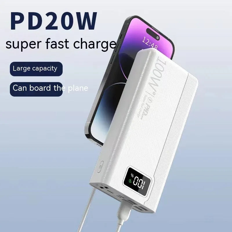 Large capacity black and white plastic power bank showing size relative to a smartphone.