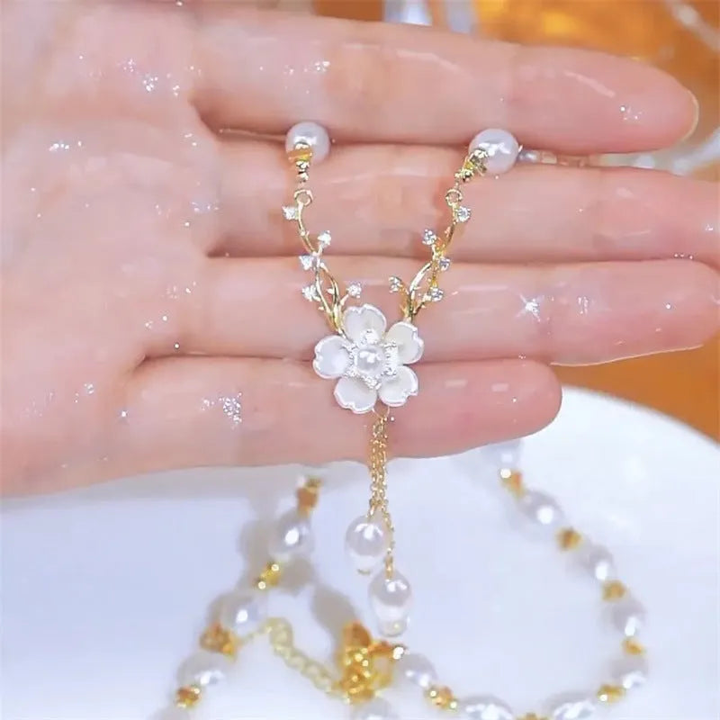 Alloy pearl necklace with floral and rose design elements on a pearl chain.