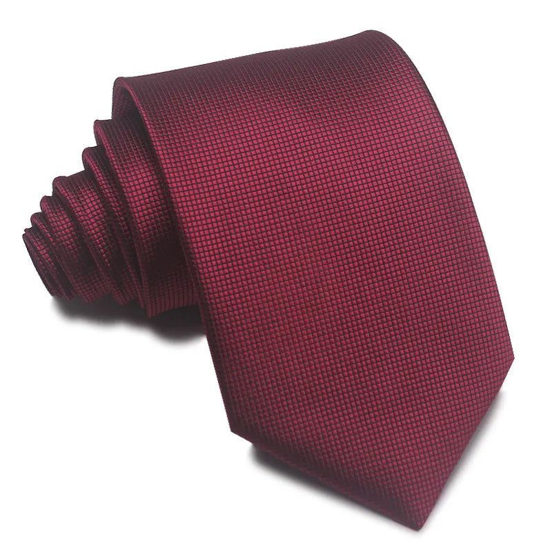 Close-up of a red, black, and blue striped men's formal tie with a textured Jacquard weave.