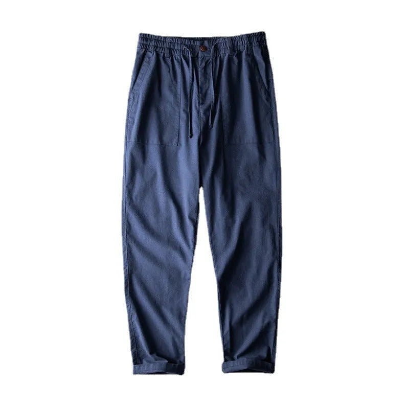 Men's casual linen trousers in solid colour with mid waist design available in navy blue, apricot linen, or grey