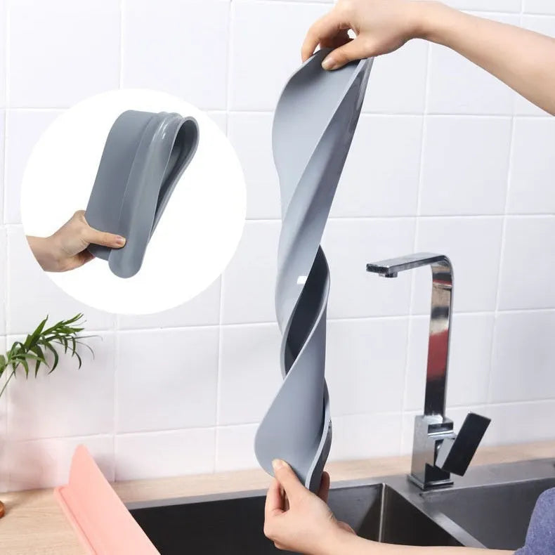Thick grey silicone sink splash guard fitted on a kitchen sink edge