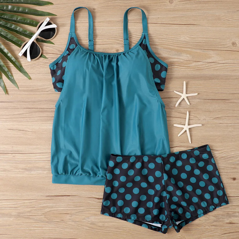 Black women's polka dot swimsuit with high-waist boxer brief bottoms.