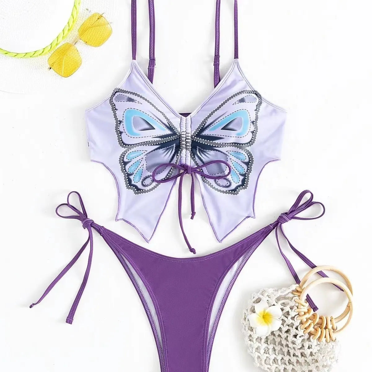Women's purple split bow back bikini swimsuit set on mannequin, showing sleeveless top and briefs.