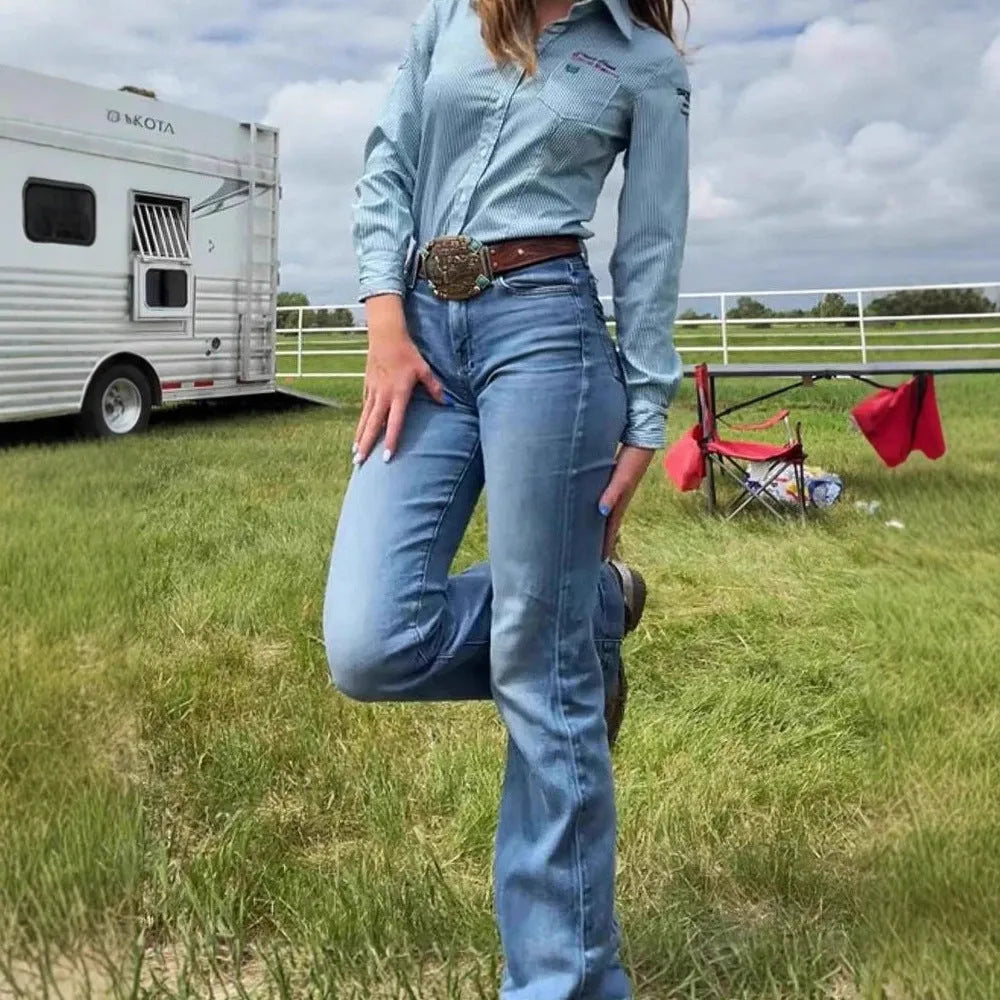 Slim fit blue denim jeans with embroidery on the leg, featuring a slight flare and a mid-rise waist.