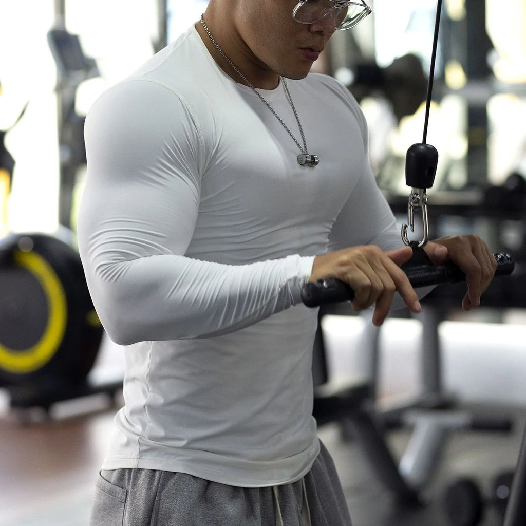 Man wearing black slim-fit long sleeve fitness tights for running or gym workout