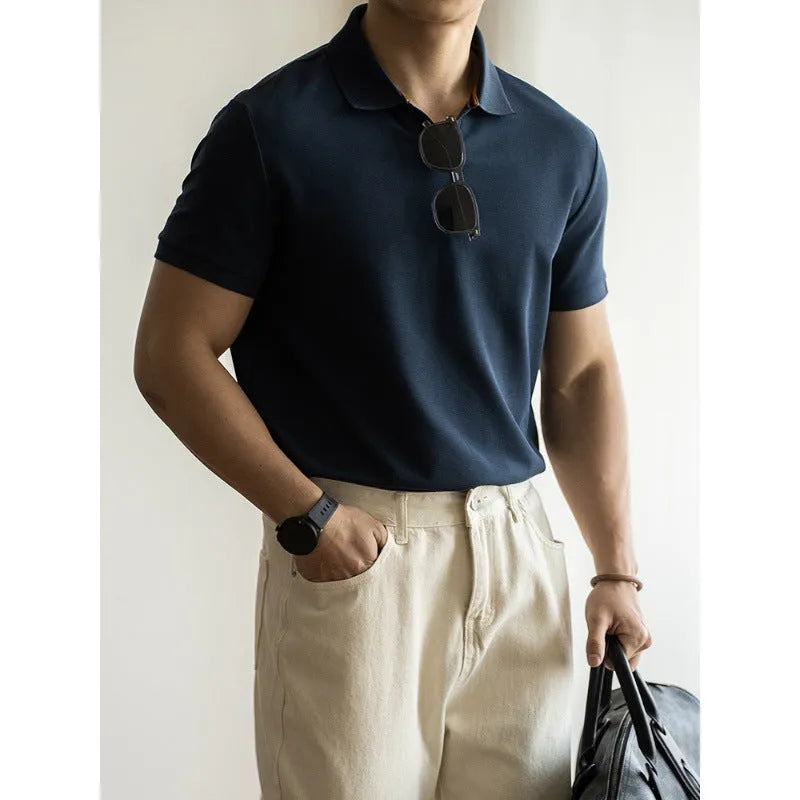 Man's blue American-style short-sleeved cotton blend polo shirt on a hanger.