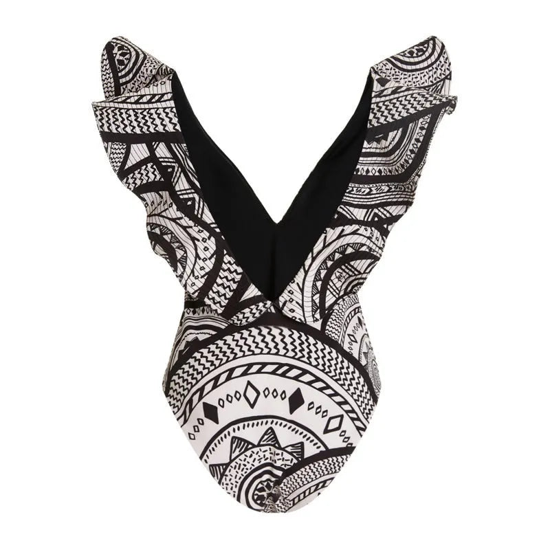 Women's vintage print one-piece swimsuit with deep V-neck and matching wrap skirt on a hanger.
