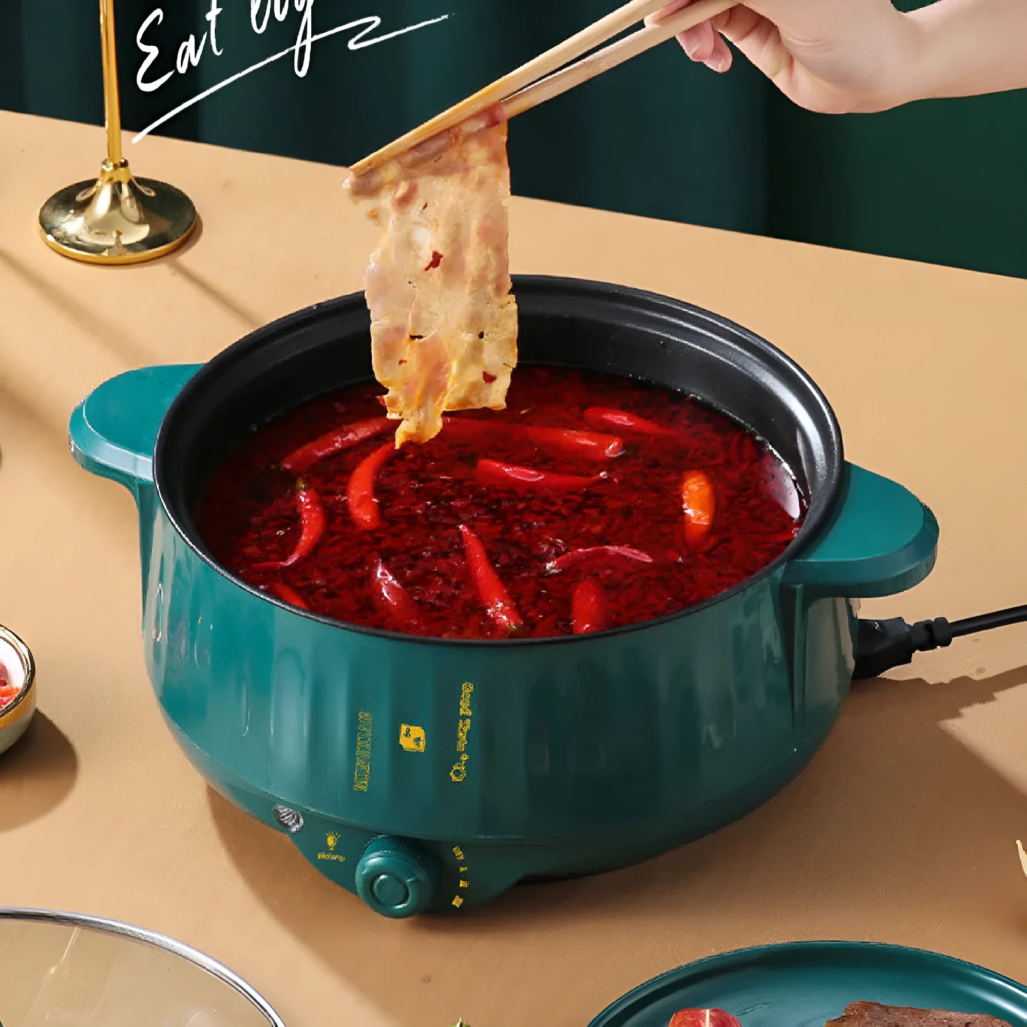 White and green non-stick electric hot pot appliance on a kitchen countertop with multiple size options.