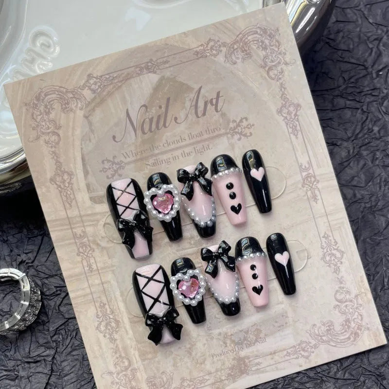 Black peach heart hand-painted detachable manicure set showing cat's eye design with bow patterns