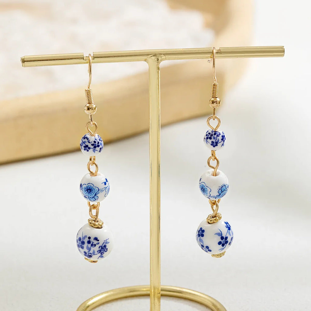 Long blue and white porcelain ceramic bead earrings with alloy frame in a retro Chinese style.