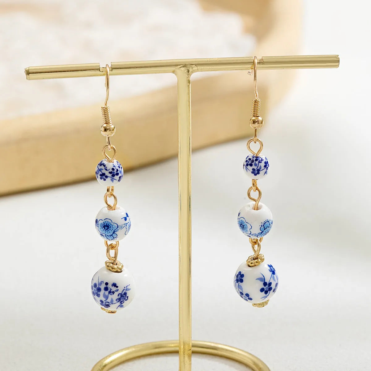 Long blue and white porcelain ceramic bead earrings with alloy frame in a retro Chinese style.