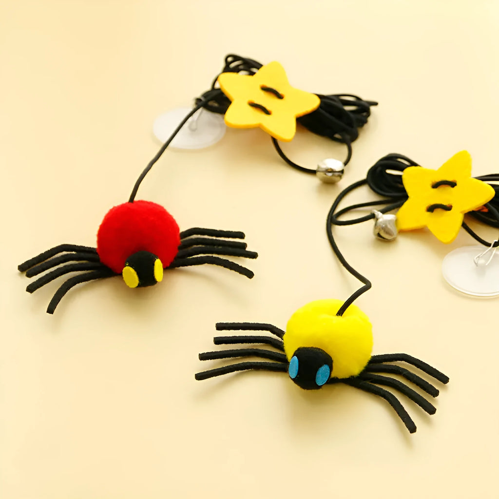 Red cat door hanging toy with elastic rope, feathers, bell, and spider attachments for interactive play