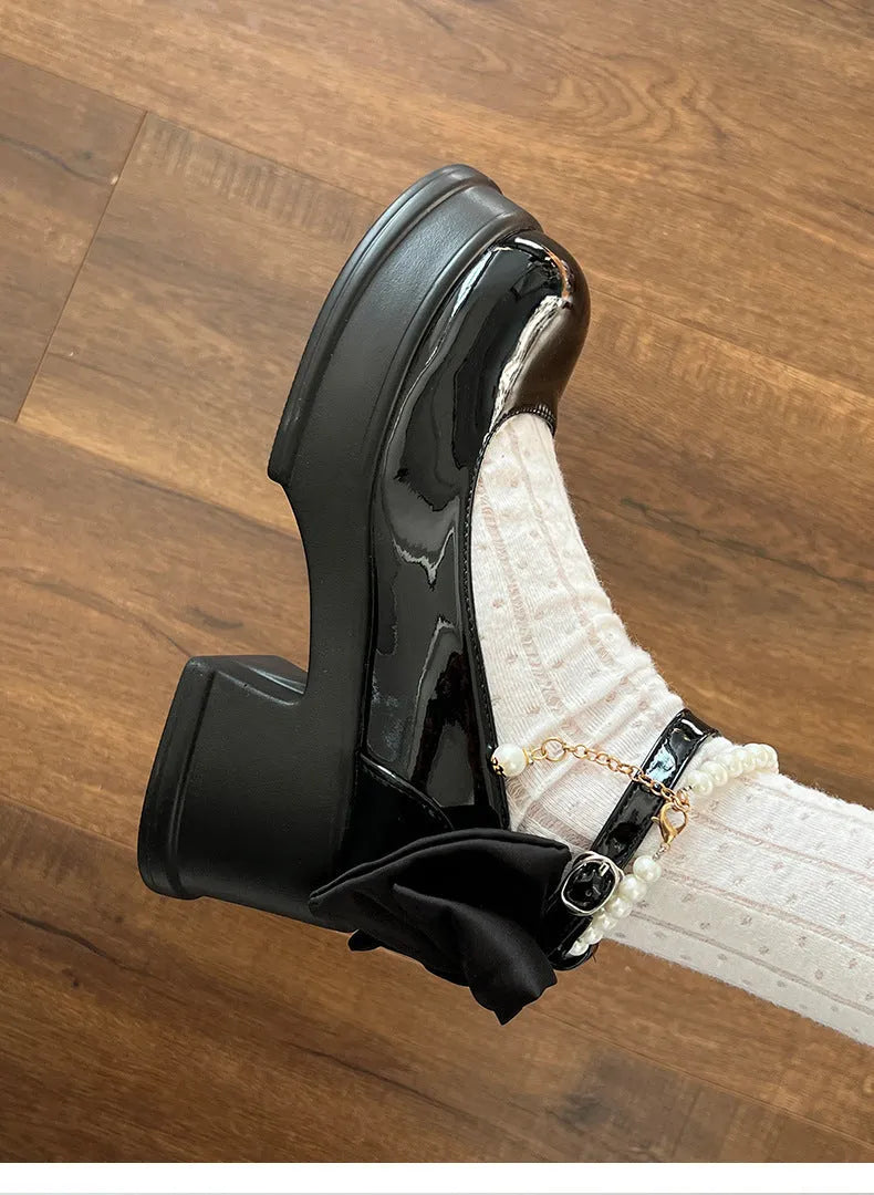 Beige and black women's Mary Jane shoes with a chunky round heel and round toe.